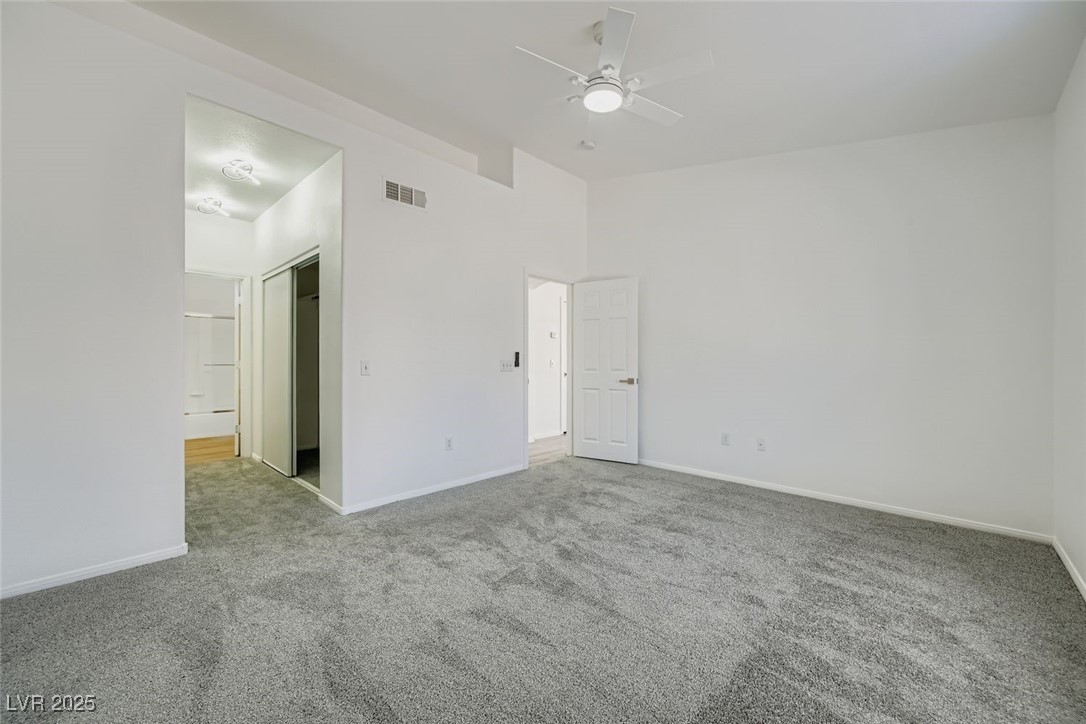 4941 Black Bear Road, Unit 203 Las Vegas, NV 89149 - Photo 7 of 11 Unfurnished bedroom with carpet, ceiling fan, and a closet