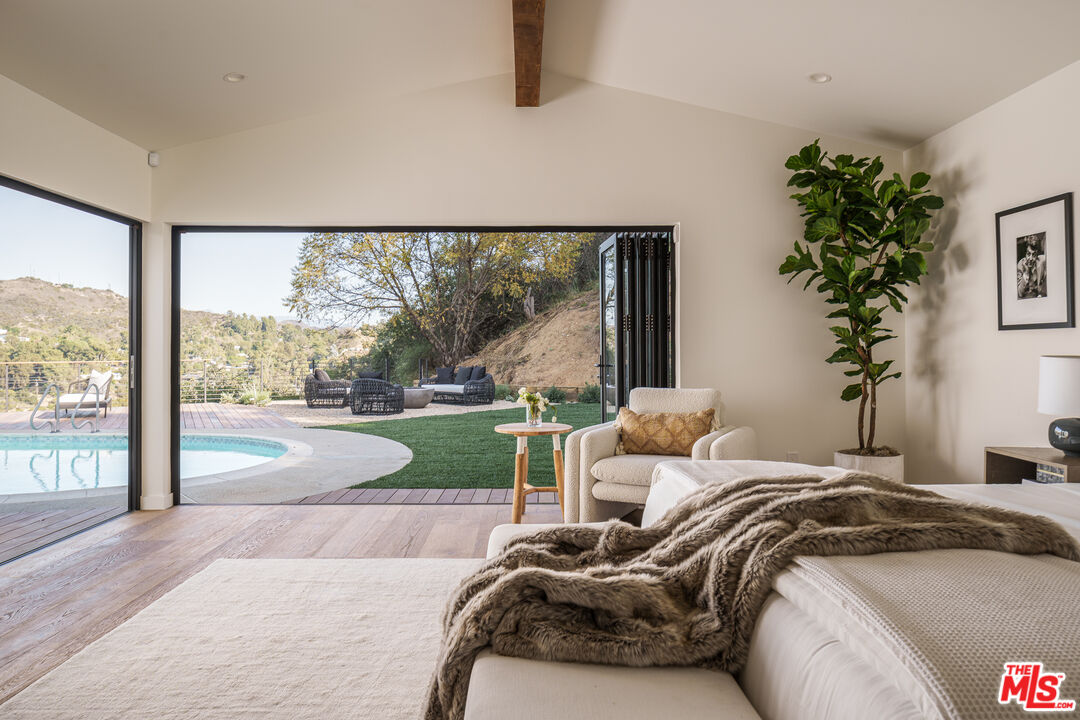 2658 Carmar Drive Los Angeles, CA 90046 - Photo 13 of 29 a bedroom with a bed couch and a large window