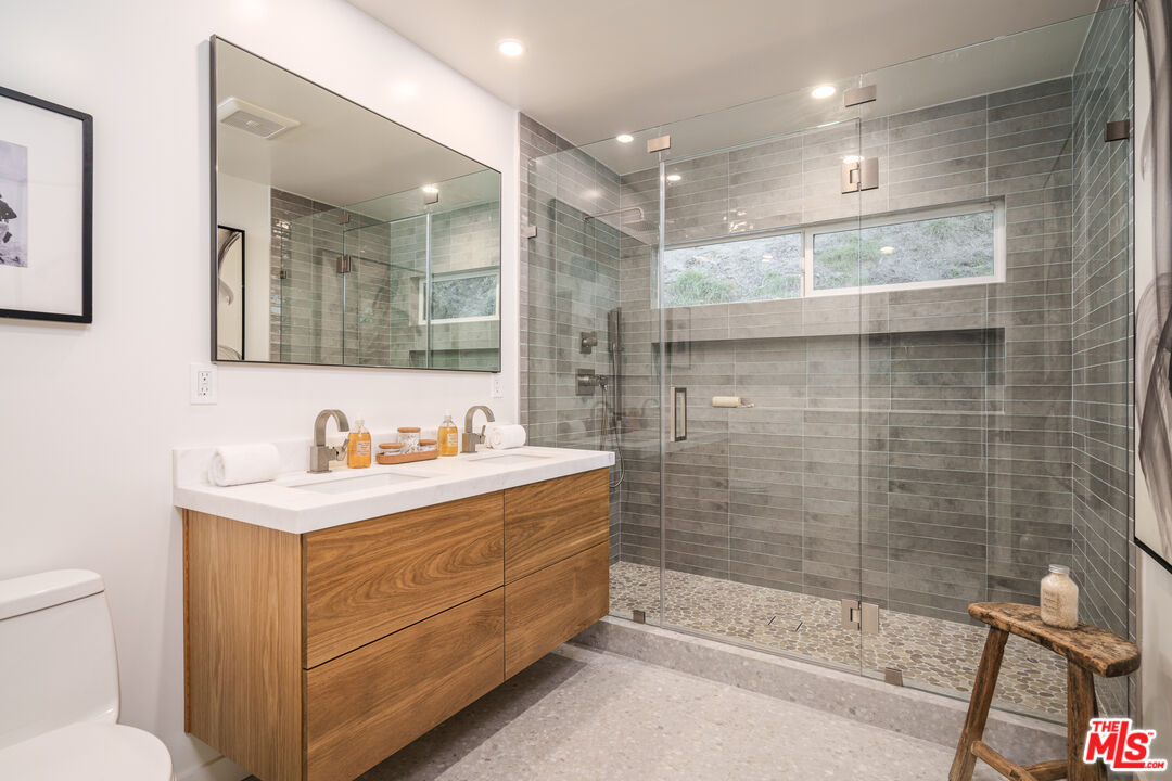 2658 Carmar Drive Los Angeles, CA 90046 - Photo 19 of 29 a bathroom with a bathtub a mirror a sink and shower