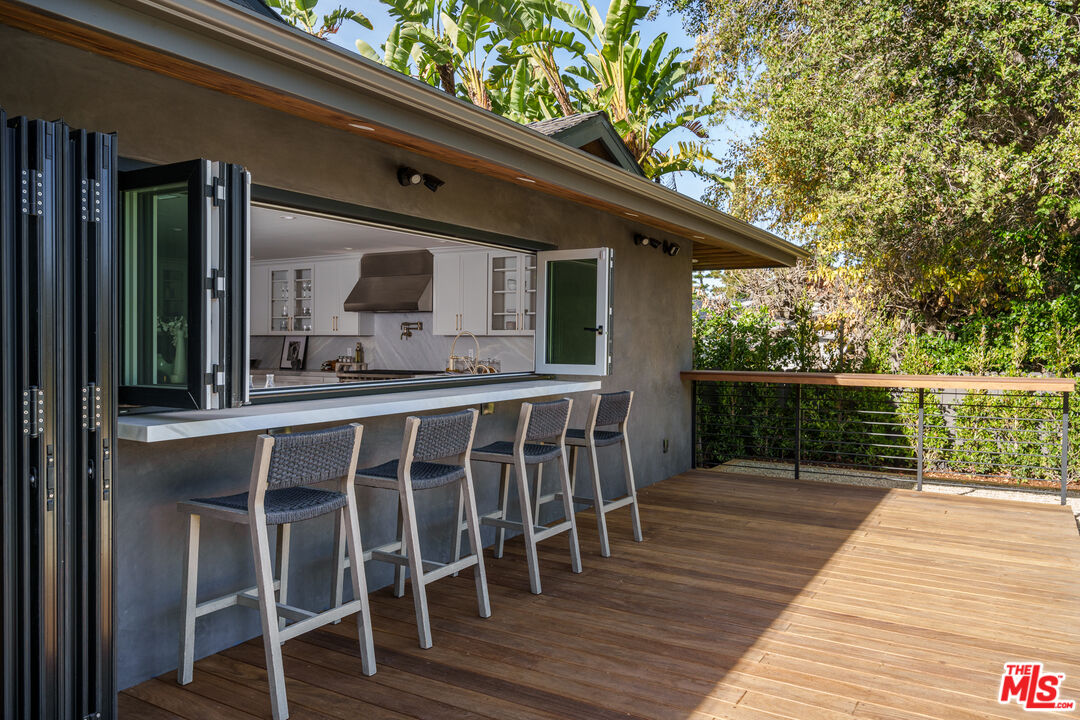 2658 Carmar Drive Los Angeles, CA 90046 - Photo 23 of 29 a front view of a house with wooden deck and furniture