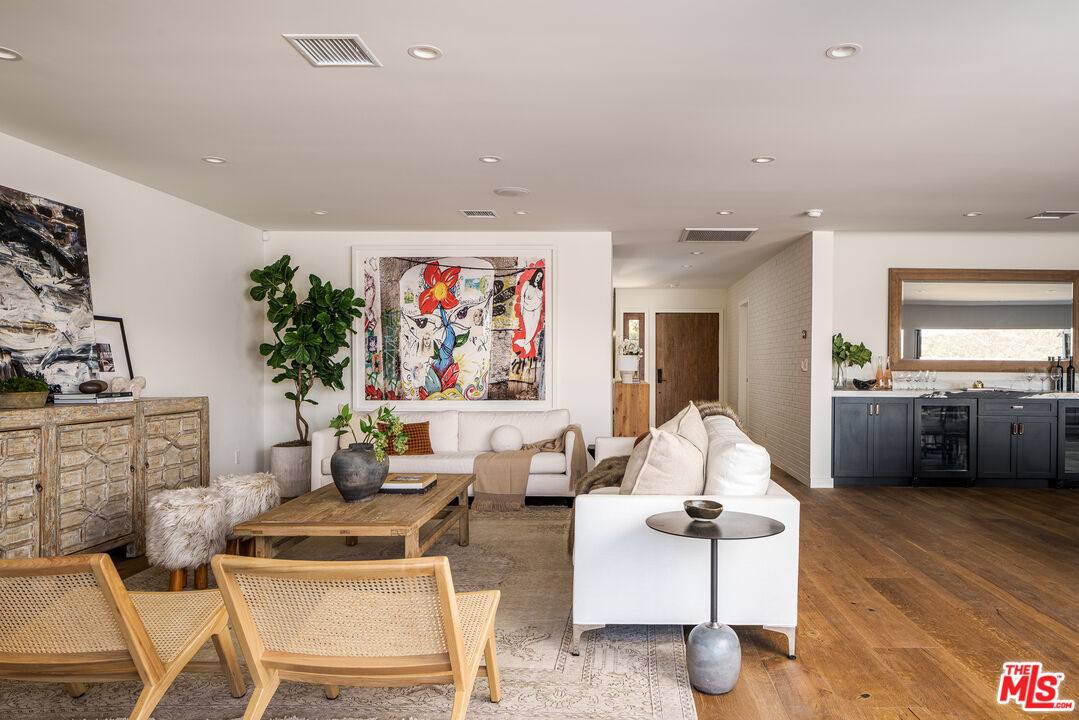 2658 Carmar Drive Los Angeles, CA 90046 - Photo 4 of 29 a living room with furniture a rug and a painting on the wall