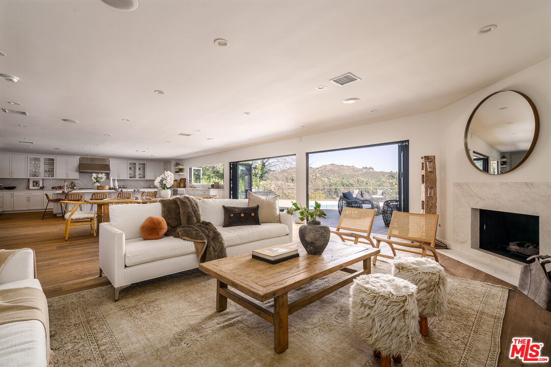 2658 Carmar Drive Los Angeles, CA 90046 - Photo 5 of 29 a living room with furniture floor to ceiling window and a fireplace