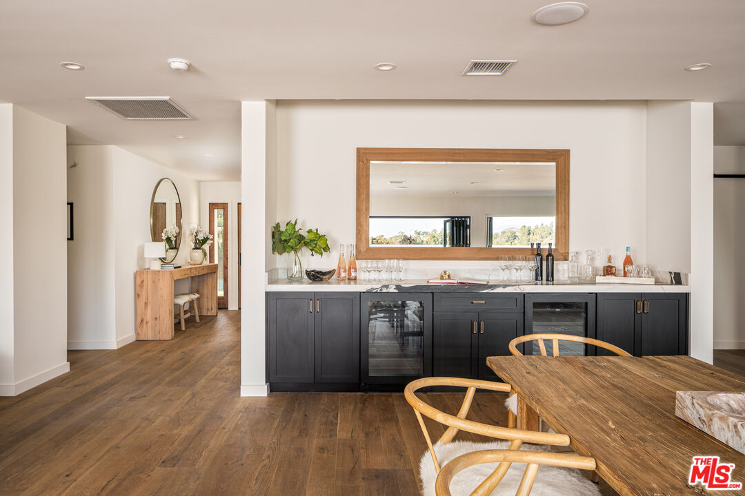 2658 Carmar Drive Los Angeles, CA 90046 - Photo 8 of 29 a kitchen with stainless steel appliances wooden floor dining table and chairs