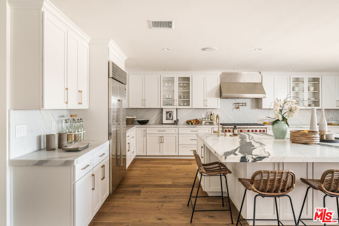 2658 Carmar Drive Los Angeles, CA 90046 - Photo 9 of 29 a large white kitchen with cabinets