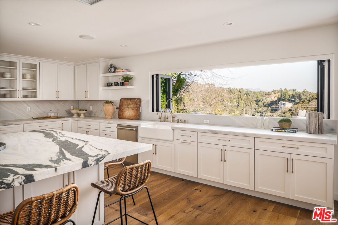 2658 Carmar Drive Los Angeles, CA 90046 - Photo 10 of 29 a kitchen with granite countertop white cabinets and white appliances