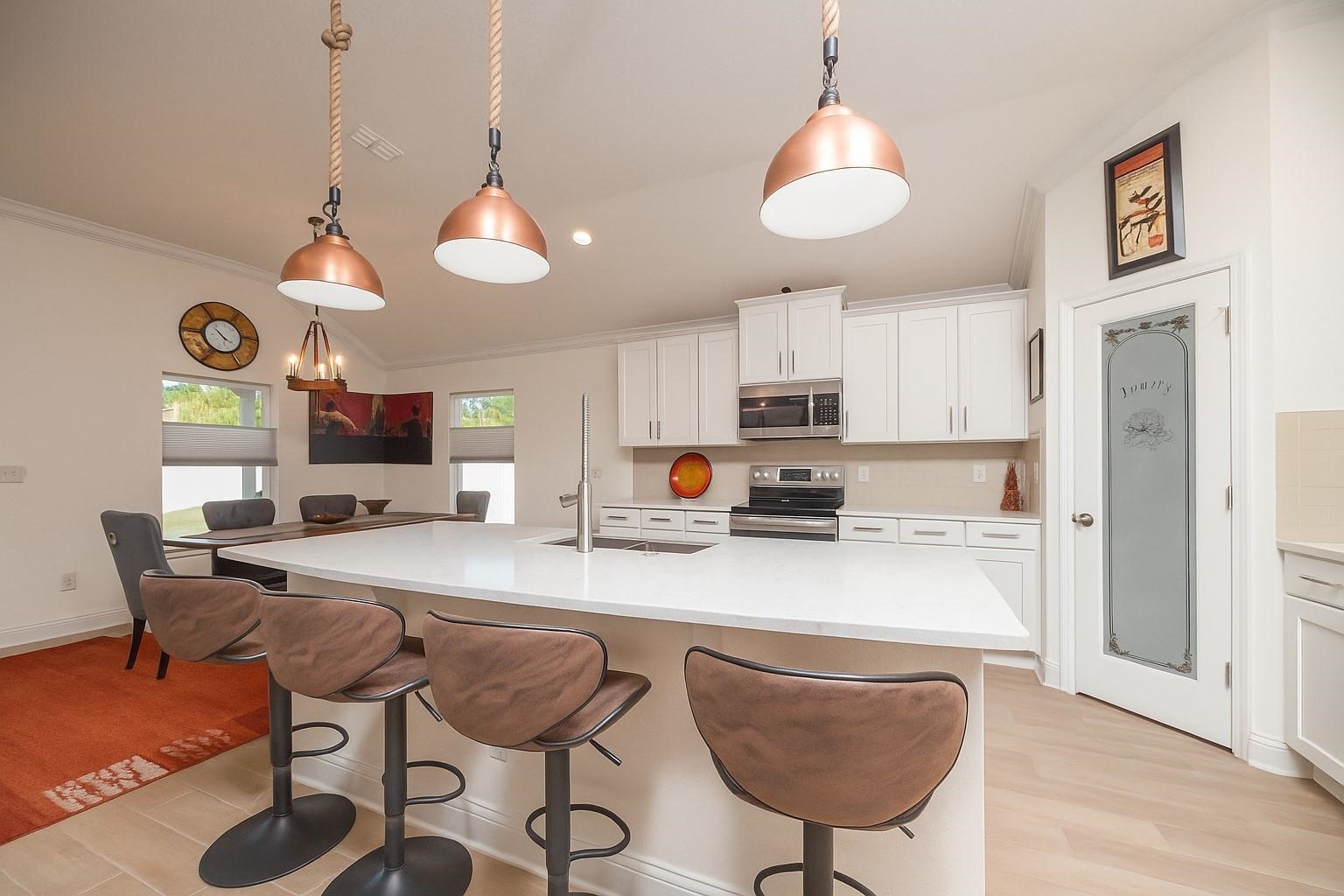 50 Salt Point St. Augustine, FL 32086 - Photo 32 of 76 a kitchen with stainless steel appliances granite countertop a refrigerator a stove a sink dishwasher a dining table and chairs with wooden floor