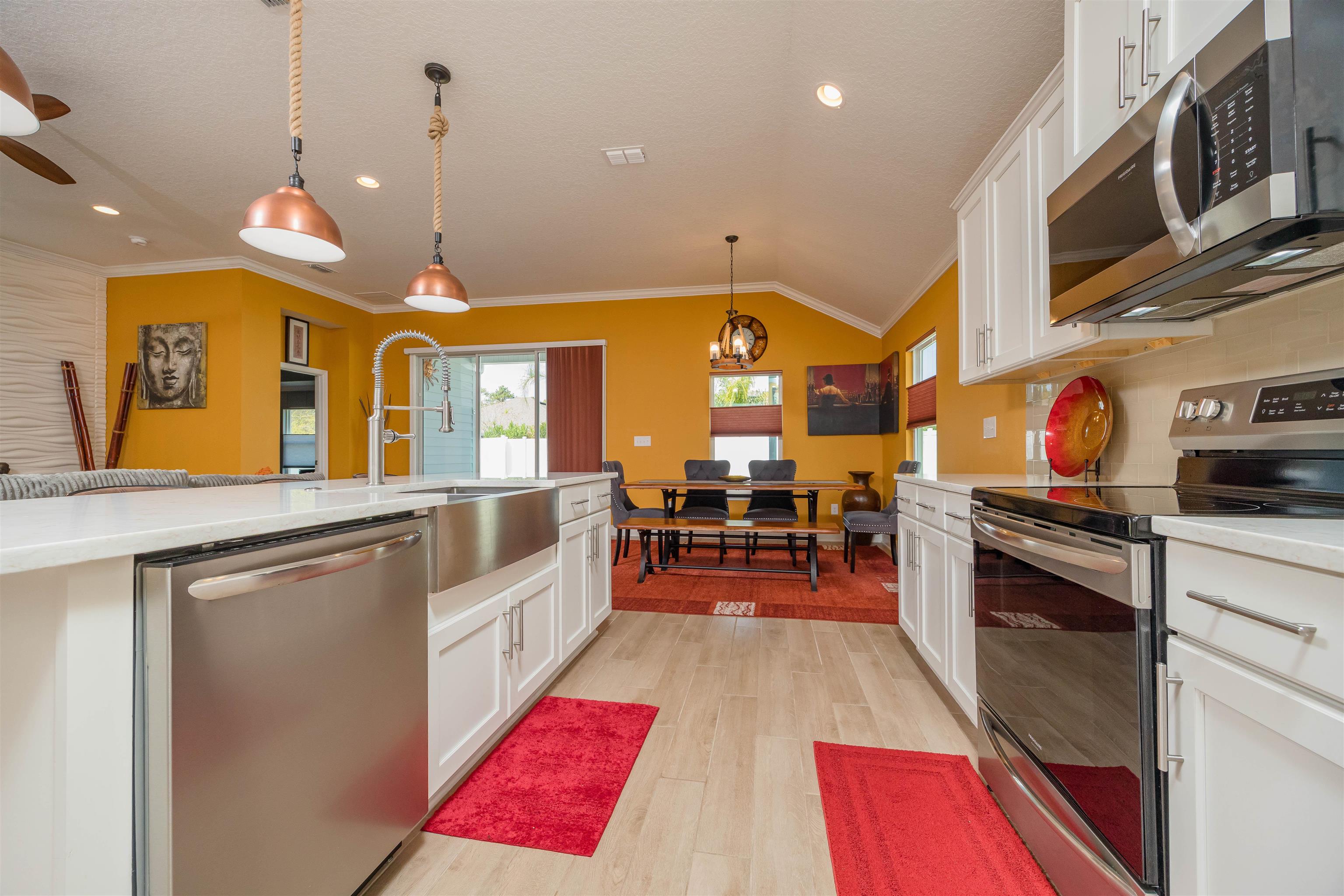 50 Salt Point St. Augustine, FL 32086 - Photo 34 of 76 a kitchen with stainless steel appliances granite countertop a stove and a wooden floors
