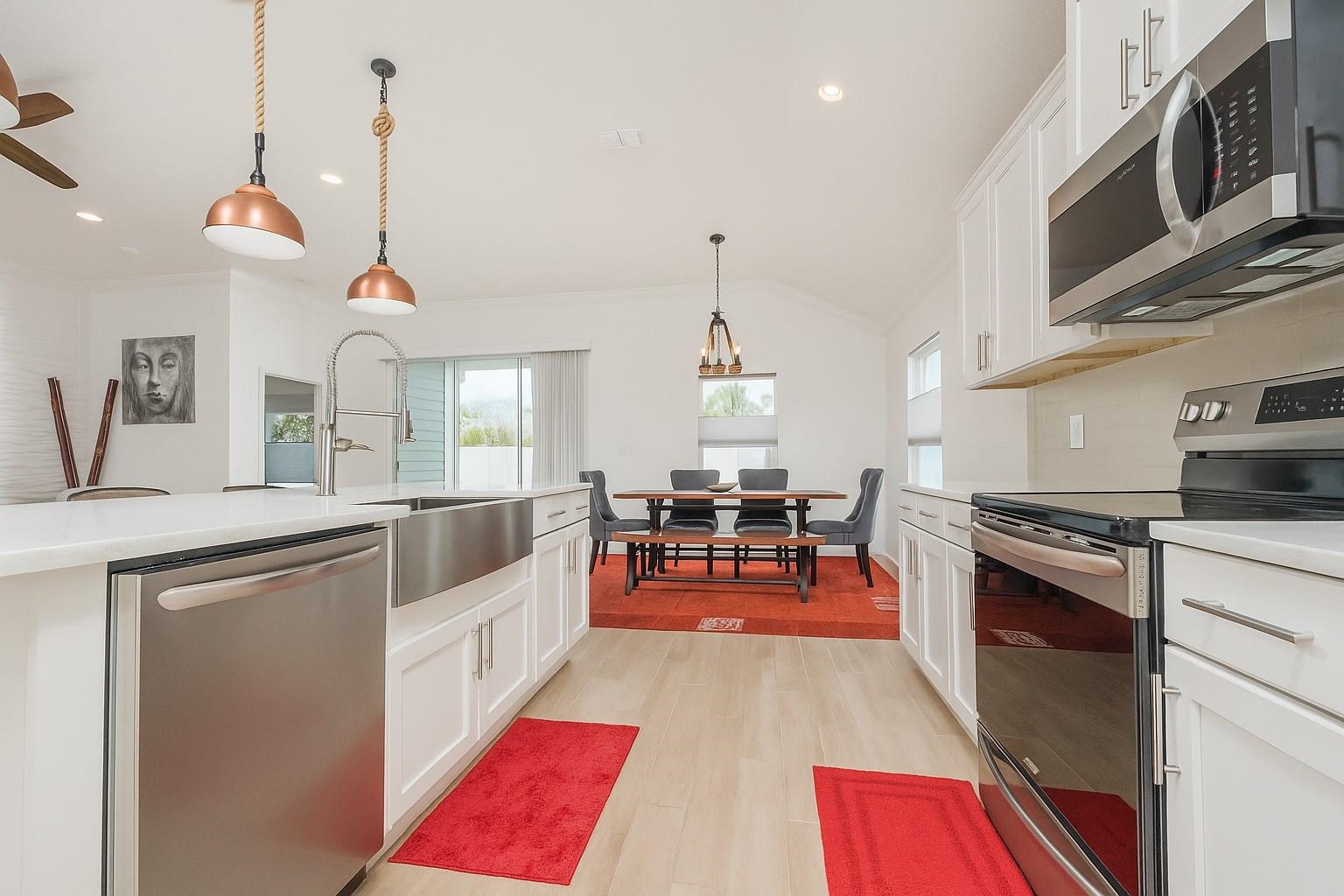 50 Salt Point St. Augustine, FL 32086 - Photo 35 of 76 Kitchen with stainless steel appliances, white cabinets, hanging light fixtures, light wood finished floors, and recessed lighting