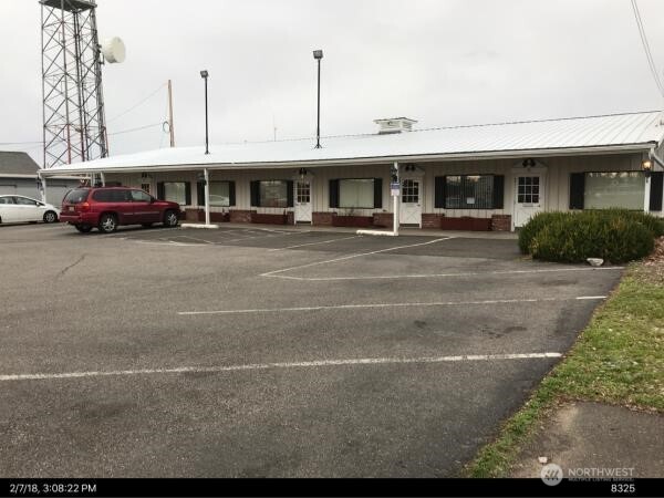 1815 Portland Avenue, Unit 3 Walla Walla, WA 99362 - Photo 13 of 16 a front view of a building with parked cars
