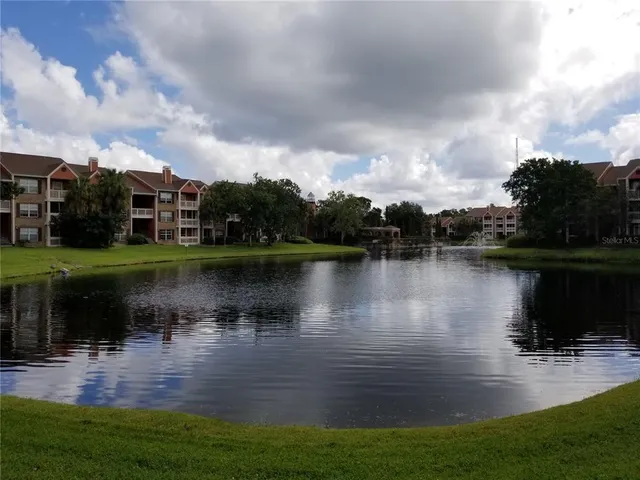 a view of a lake with houses in the back