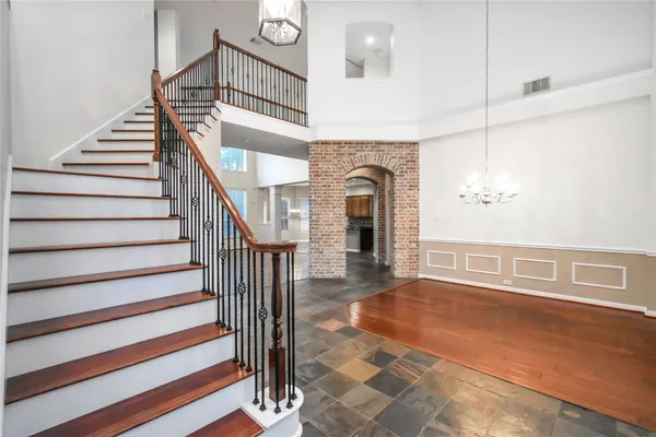 a view of entryway and hall with wooden floor