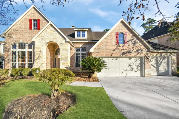 a front view of a house with a yard and outdoor seating