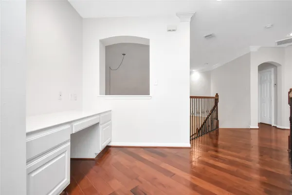 an empty room with a ceiling fan and wooden floor
