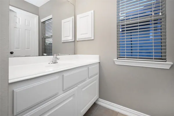 a white toilet sitting next to a bathroom sink