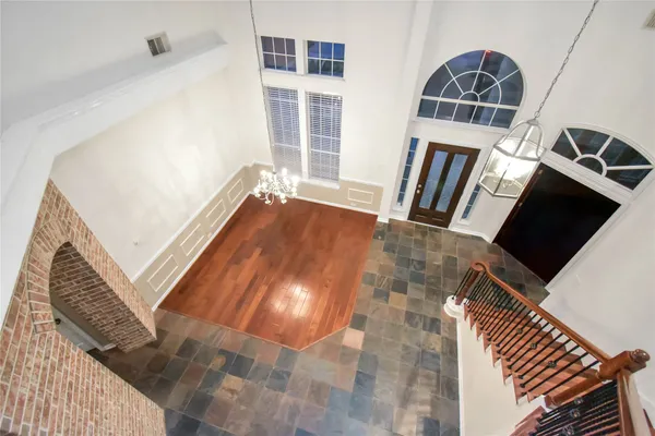a view of an empty room with wooden floor and fire place
