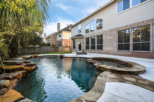 a swimming pool with outdoor seating and yard