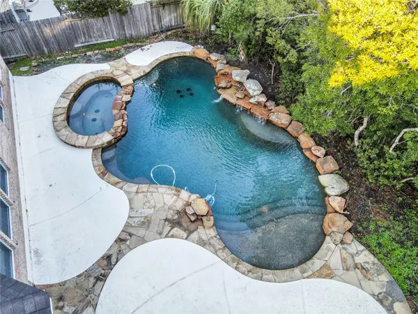 a view of a house with pool and chairs