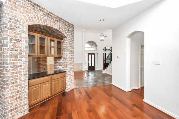 a view of a hallway with wooden floor and entryway