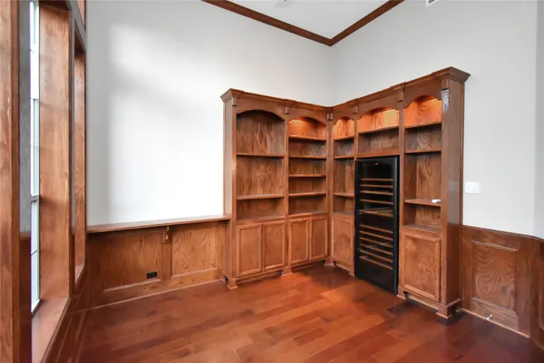 a room with walk in closet and wooden floor