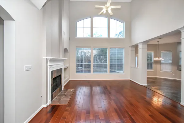 a view of empty room with wooden floor and fireplace