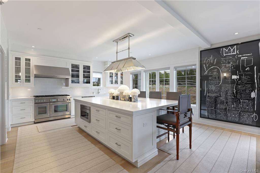 a kitchen with stainless steel appliances a stove top oven and cabinets