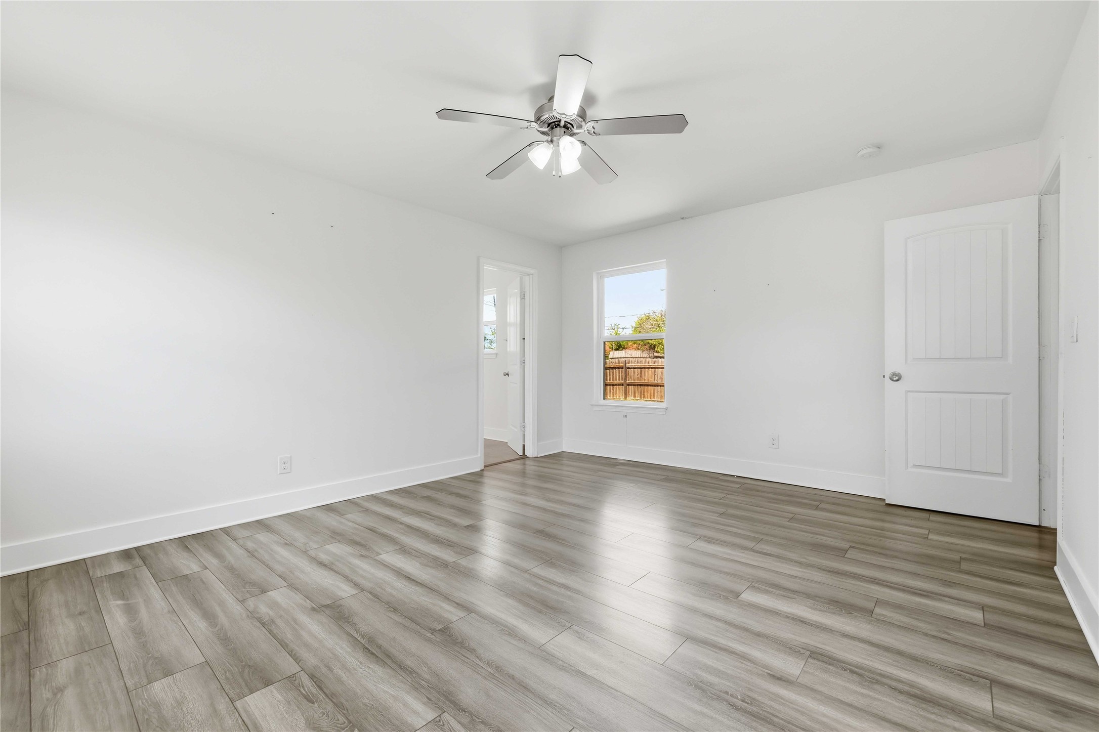 400 Booth Street Taylor, TX 76574 - Photo 18 of 35 Empty room with light wood finished floors and ceiling fan
