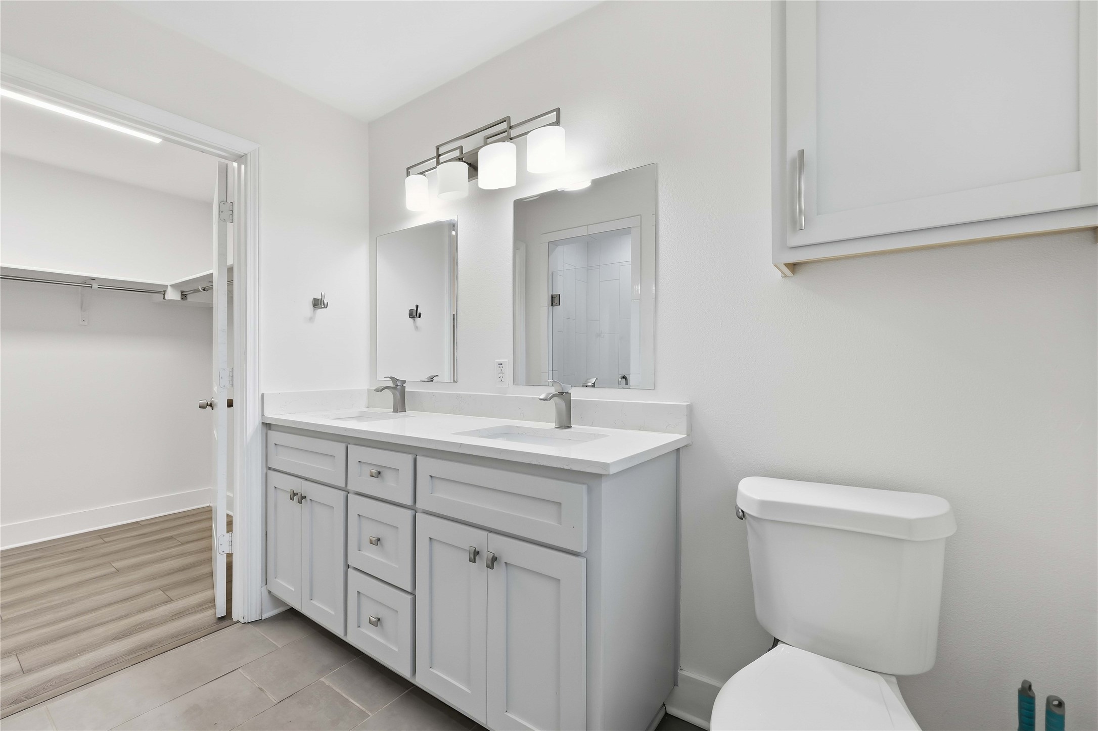 400 Booth Street Taylor, TX 76574 - Photo 19 of 35 Full bathroom featuring double vanity, a spacious closet, and light tile patterned floors