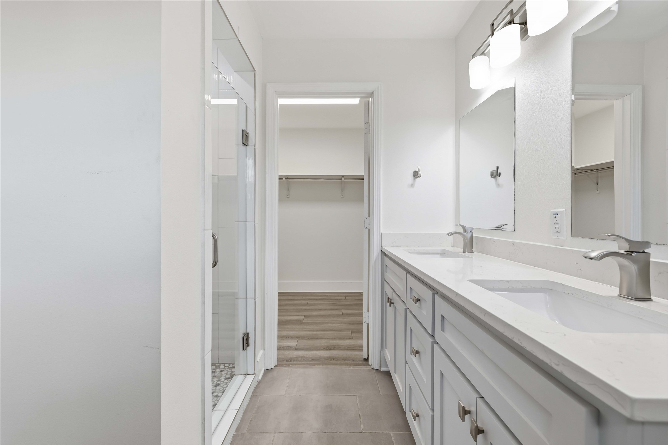 400 Booth Street Taylor, TX 76574 - Photo 21 of 35 Full bathroom featuring a spacious closet, double vanity, a stall shower, and light tile patterned flooring