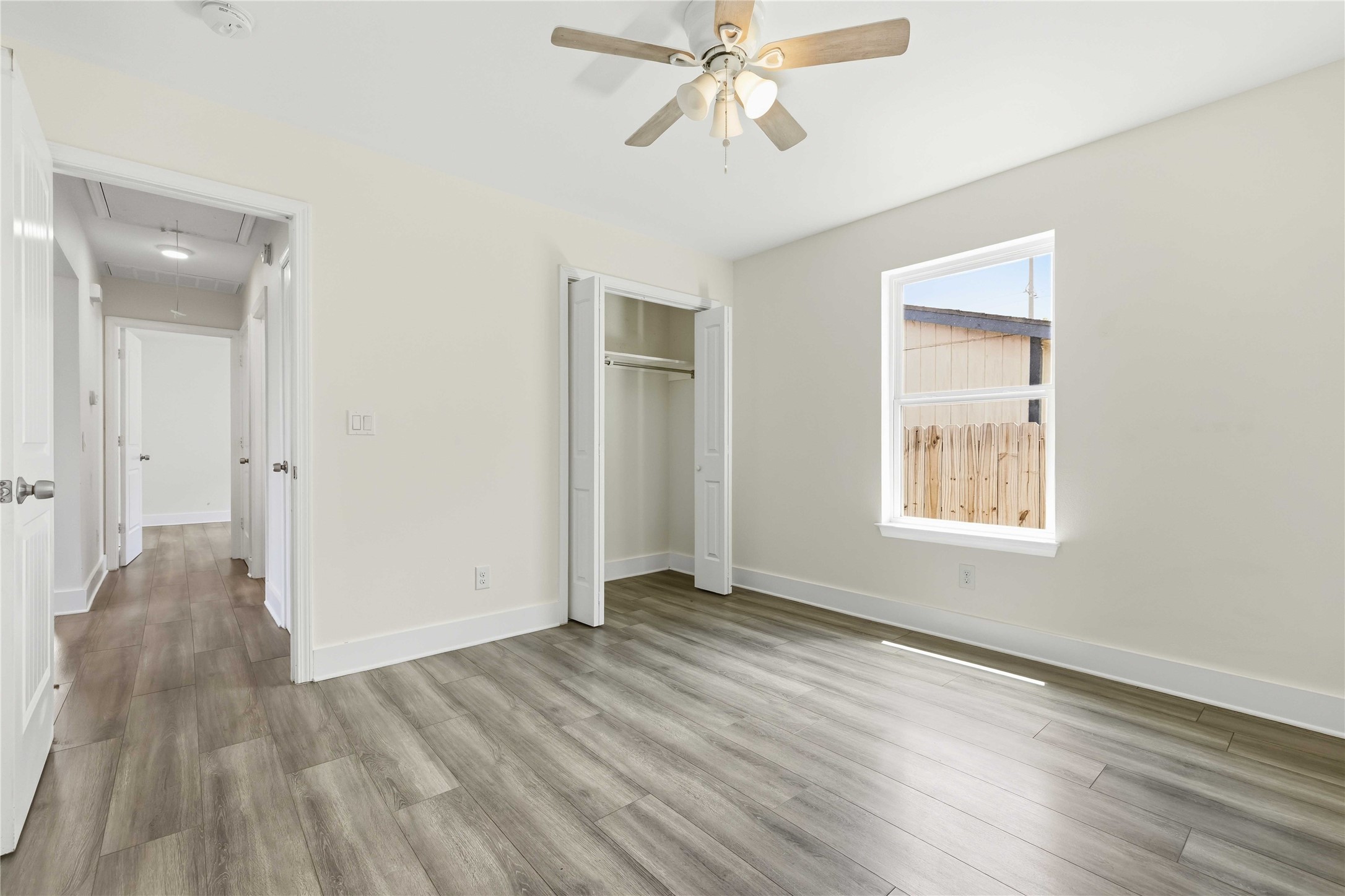 400 Booth Street Taylor, TX 76574 - Photo 24 of 35 Unfurnished bedroom with light wood-style floors, a closet, and a ceiling fan
