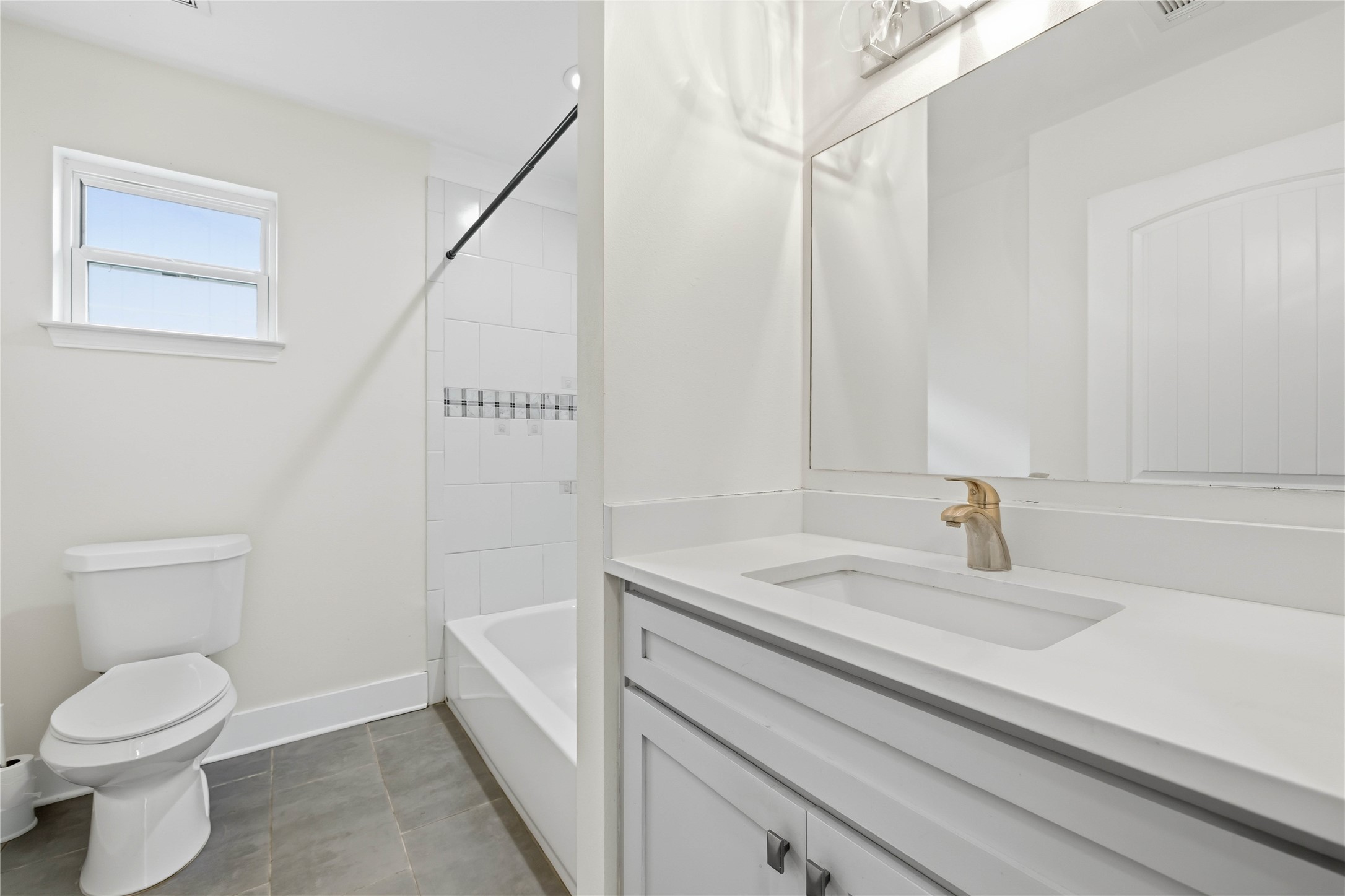 400 Booth Street Taylor, TX 76574 - Photo 25 of 35 Full bath featuring vanity, tub / shower combination, and dark tile patterned flooring