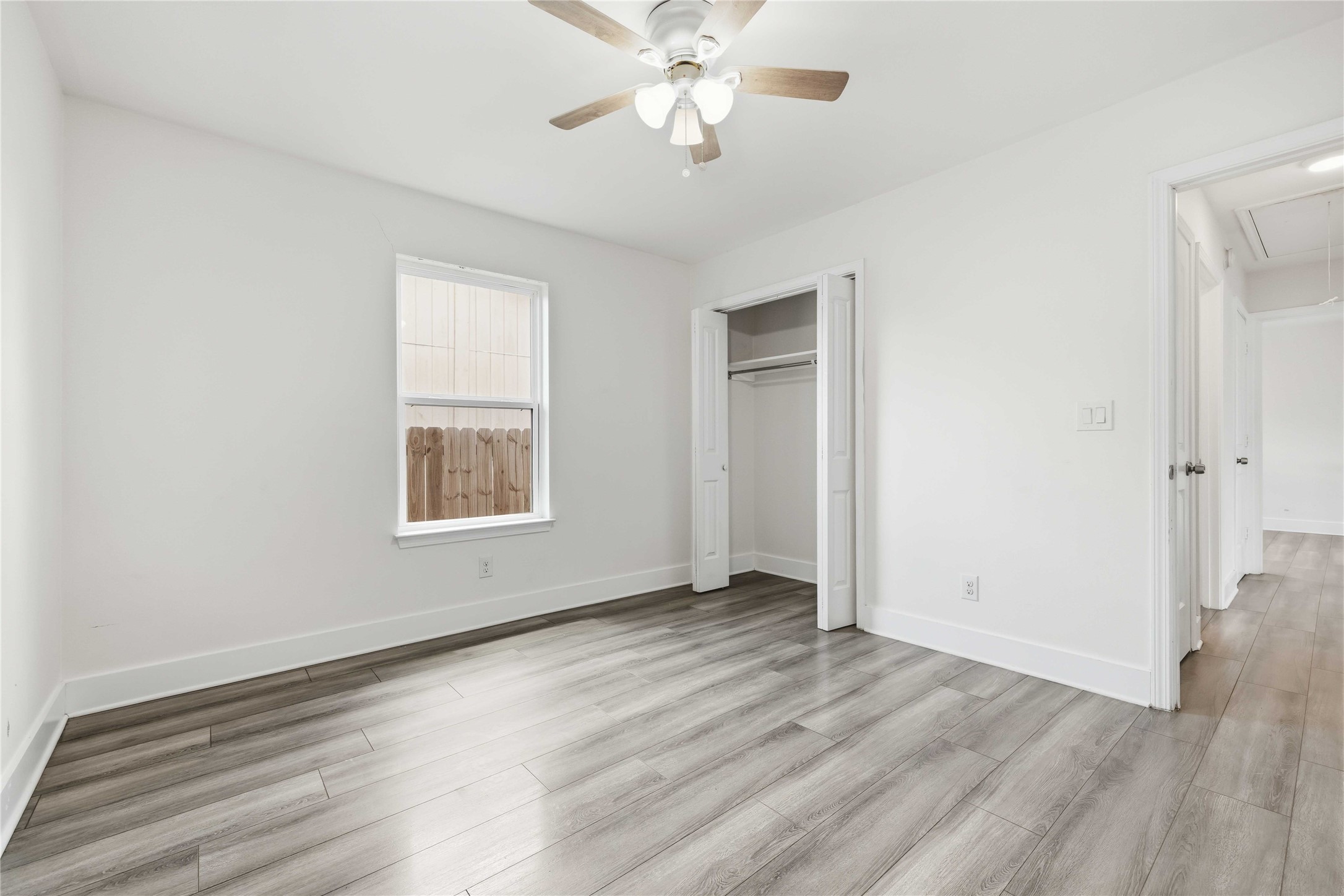 400 Booth Street Taylor, TX 76574 - Photo 27 of 35 Unfurnished bedroom with ceiling fan, light wood-style flooring, and a closet