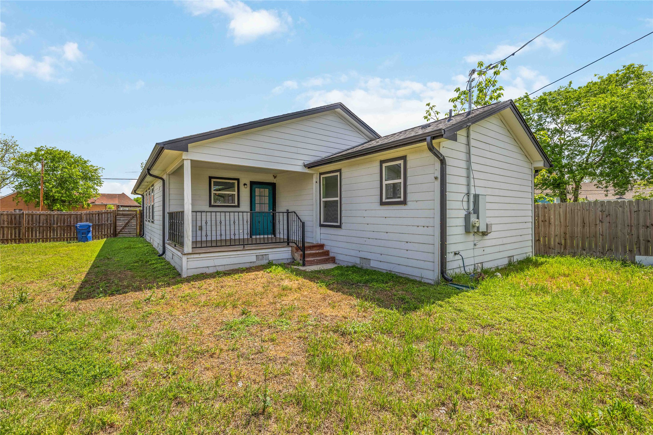 400 Booth Street Taylor, TX 76574 - Photo 33 of 35 Rear view of house featuring a fenced backyard and a porch