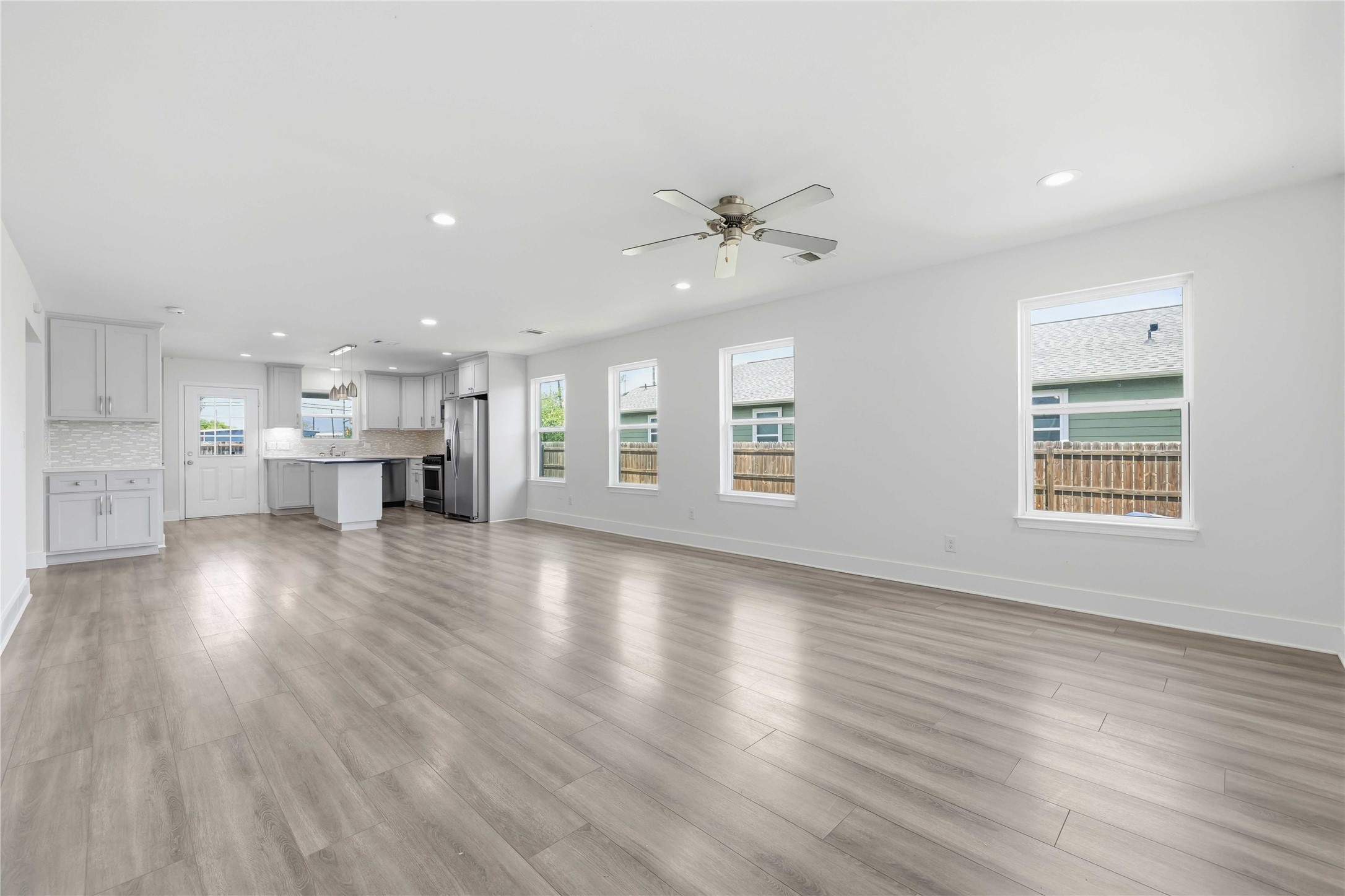 400 Booth Street Taylor, TX 76574 - Photo 8 of 35 Unfurnished living room featuring recessed lighting, ceiling fan, and light wood finished floors