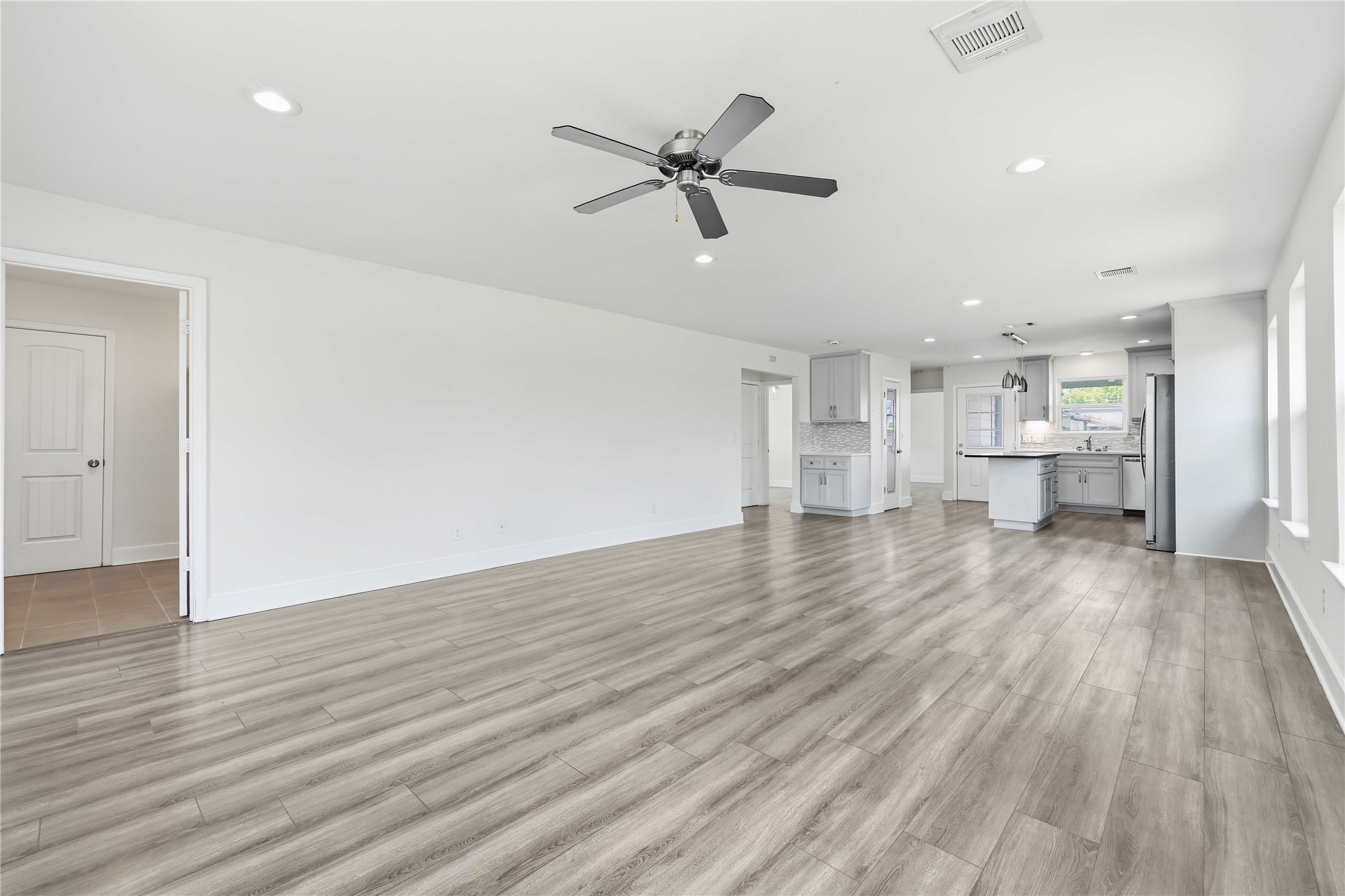 400 Booth Street Taylor, TX 76574 - Photo 9 of 35 Unfurnished living room with ceiling fan, recessed lighting, and light wood-style floors