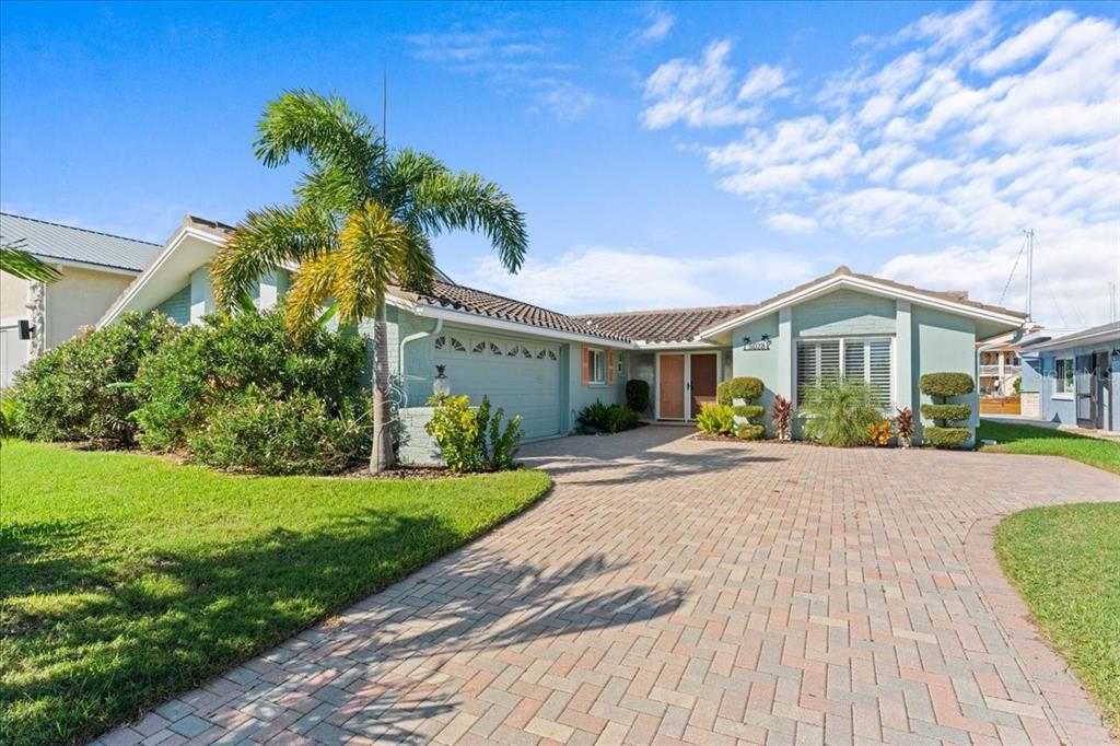 5028 Ensign Loop New Port Richey, FL 34652 - Photo 2 of 76 a front view of a house with a garden