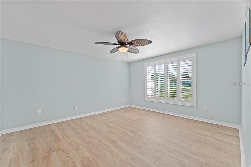 5028 Ensign Loop New Port Richey, FL 34652 - Photo 22 of 76 a view of a room with a ceiling fan and wooden floor