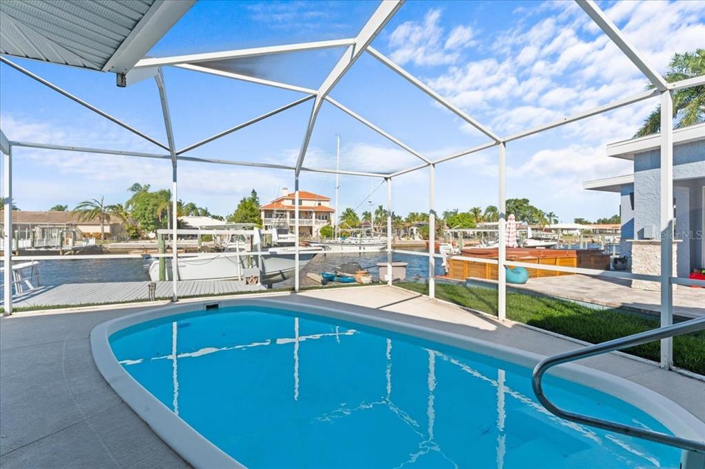 5028 Ensign Loop New Port Richey, FL 34652 - Photo 45 of 76 a view of a backyard with table and chairs under an umbrella