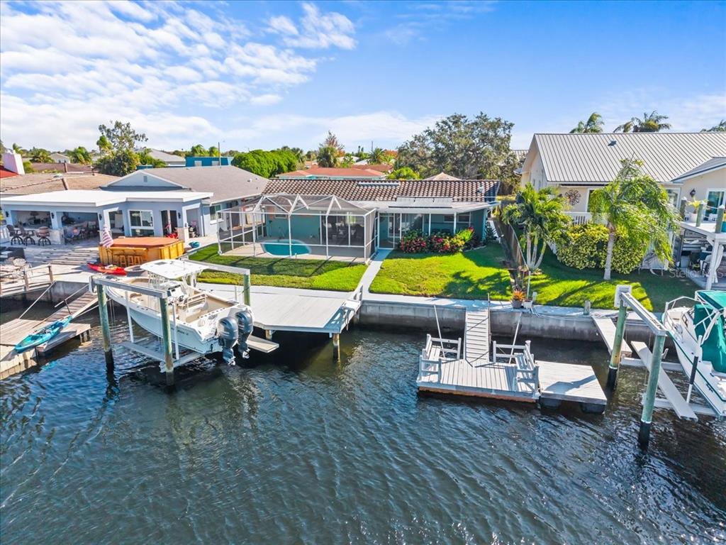 5028 Ensign Loop New Port Richey, FL 34652 - Photo 56 of 76 a view of a swimming pool with lounge chairs in front of house