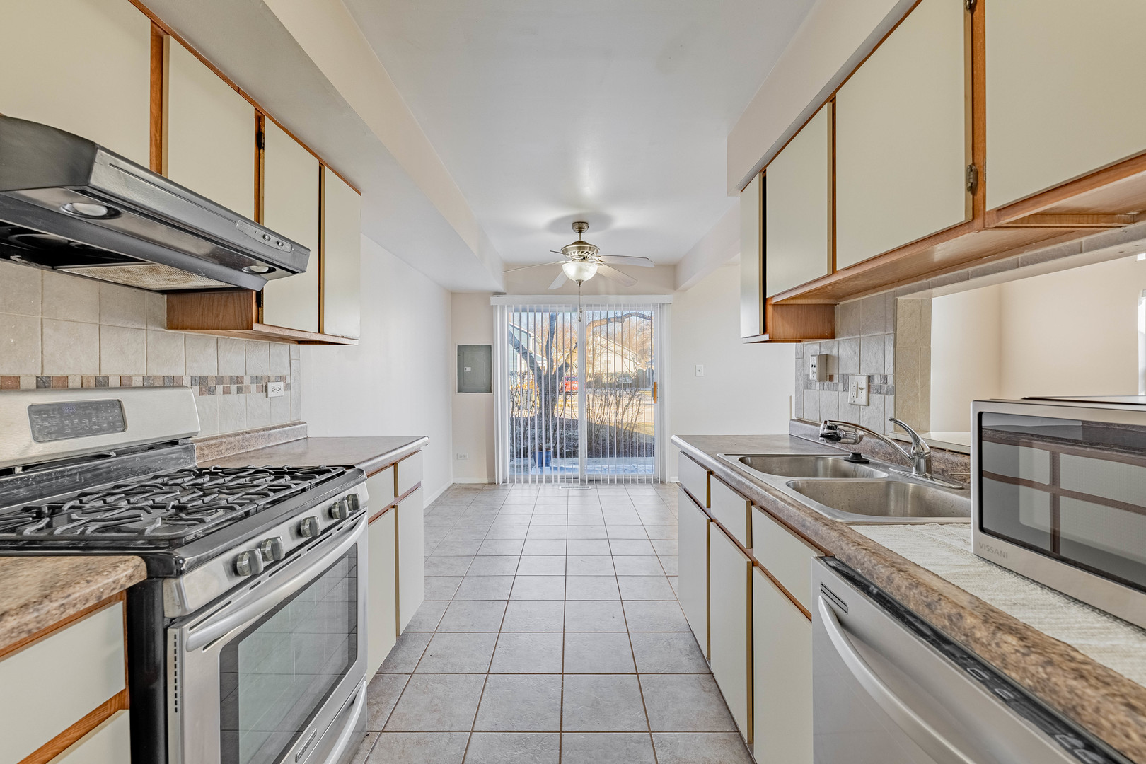 237 Acorn Drive Streamwood, IL 60107 - Photo 9 of 31 a kitchen with stainless steel appliances granite countertop a sink stove and cabinets