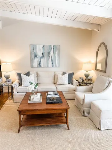 a living room with furniture and white walls