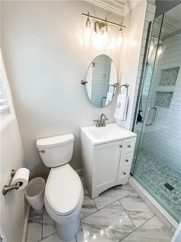 a bathroom with a sink toilet and a mirror