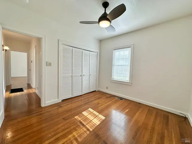 a view of a room with a ceiling fan