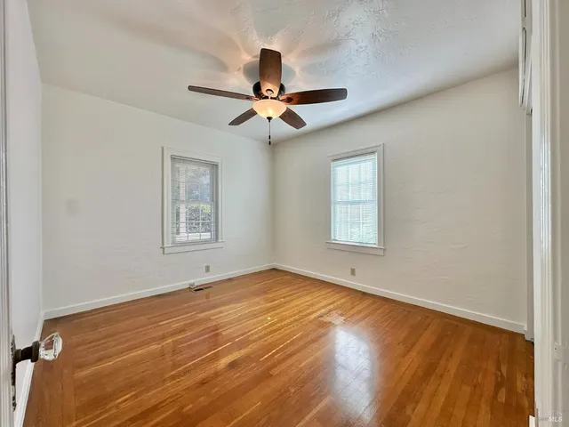 a bedroom with a bed and a ceiling fan