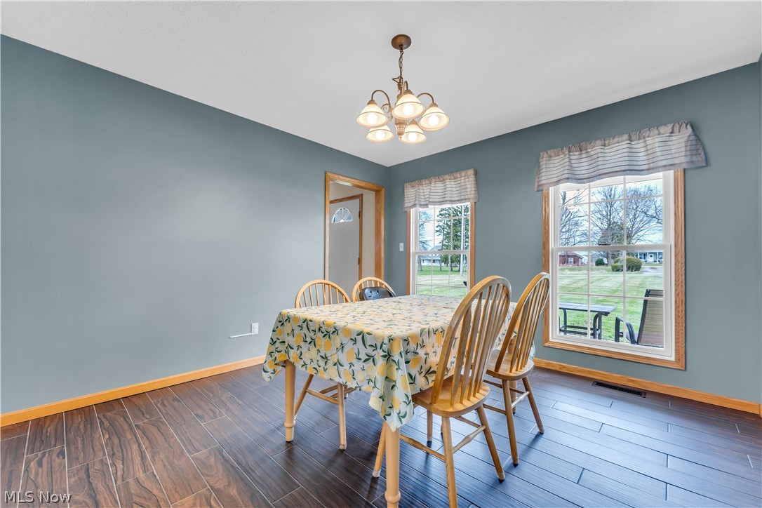 2560 Blake Road Wadsworth, OH 44281 - Photo 17 of 30 Dining area featuring a chandelier and dark ceramic tile / wood-style flooring