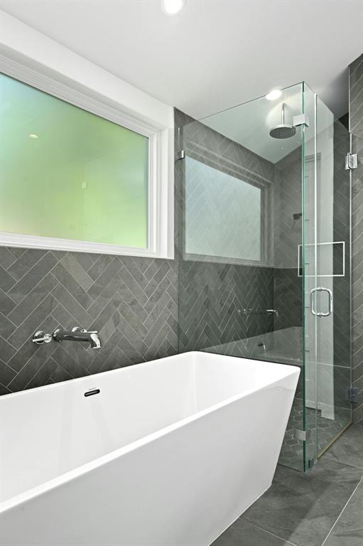 5212 Huisache Street, Unit 2 Austin, TX 78751 - Photo 21 of 30 Bathroom with a freestanding tub, a stall shower, and tile walls