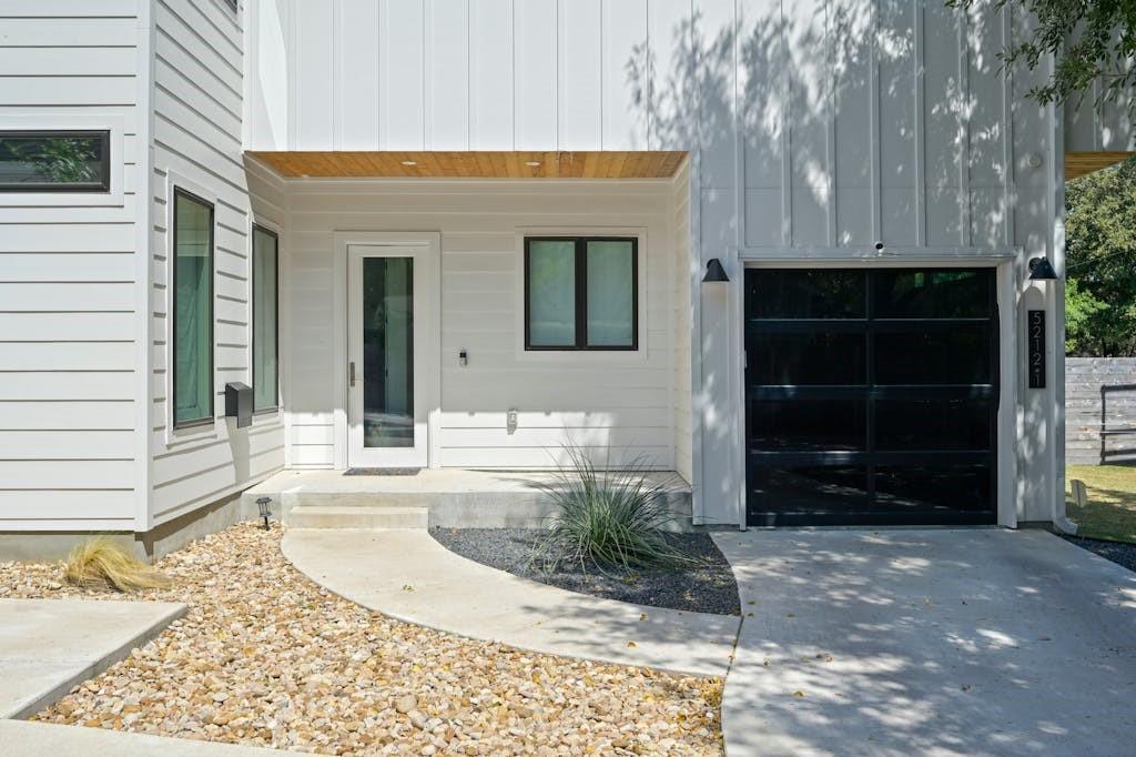 5212 Huisache Street, Unit 2 Austin, TX 78751 - Photo 3 of 30 Entrance to property featuring a porch, an attached garage, and driveway