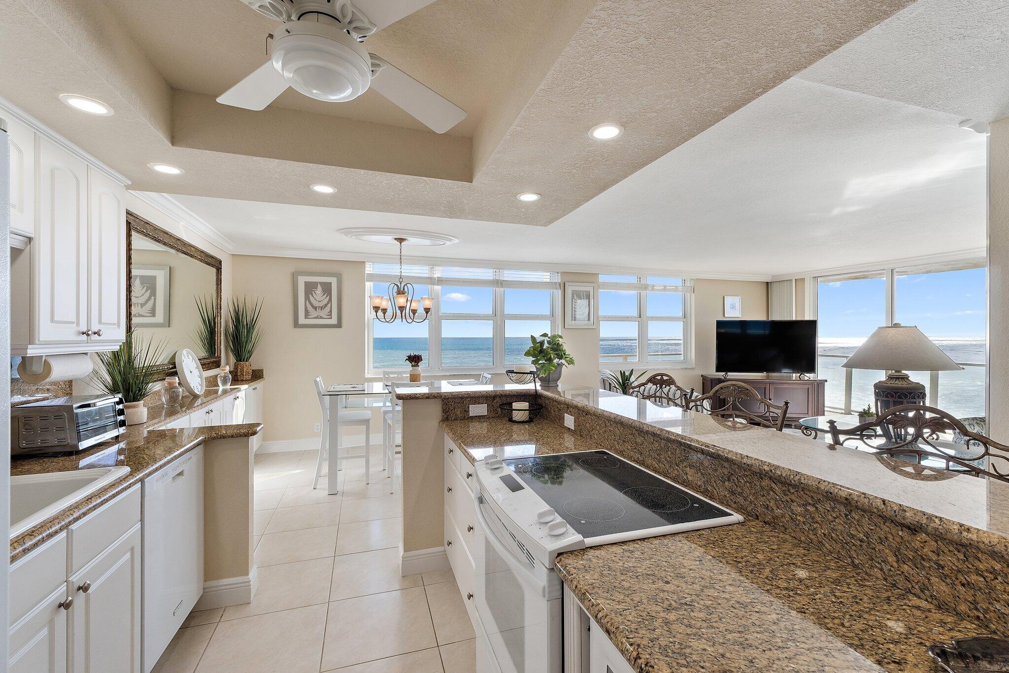 Undisclosed Address Singer Island, FL 33404 - Photo 13 of 77 a kitchen with a sink a counter top space and living room view