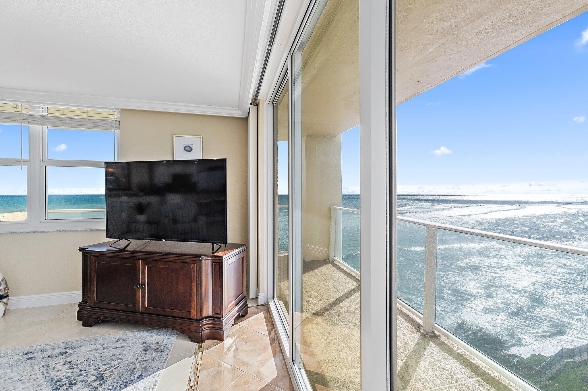 Undisclosed Address Singer Island, FL 33404 - Photo 20 of 77 a living room with a flat screen tv and a glass door