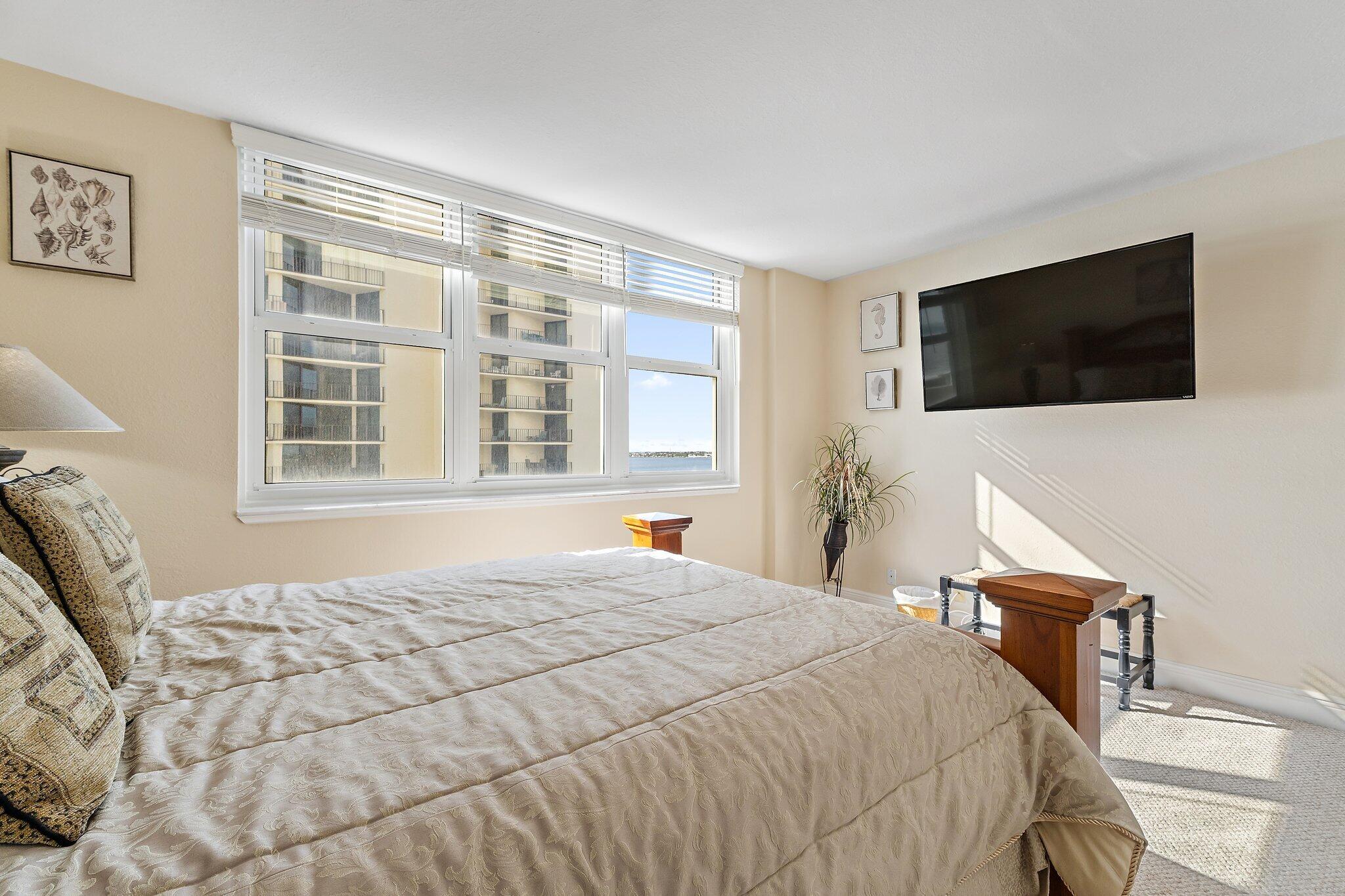 Undisclosed Address Singer Island, FL 33404 - Photo 30 of 77 a bedroom with a bed and a flat screen tv