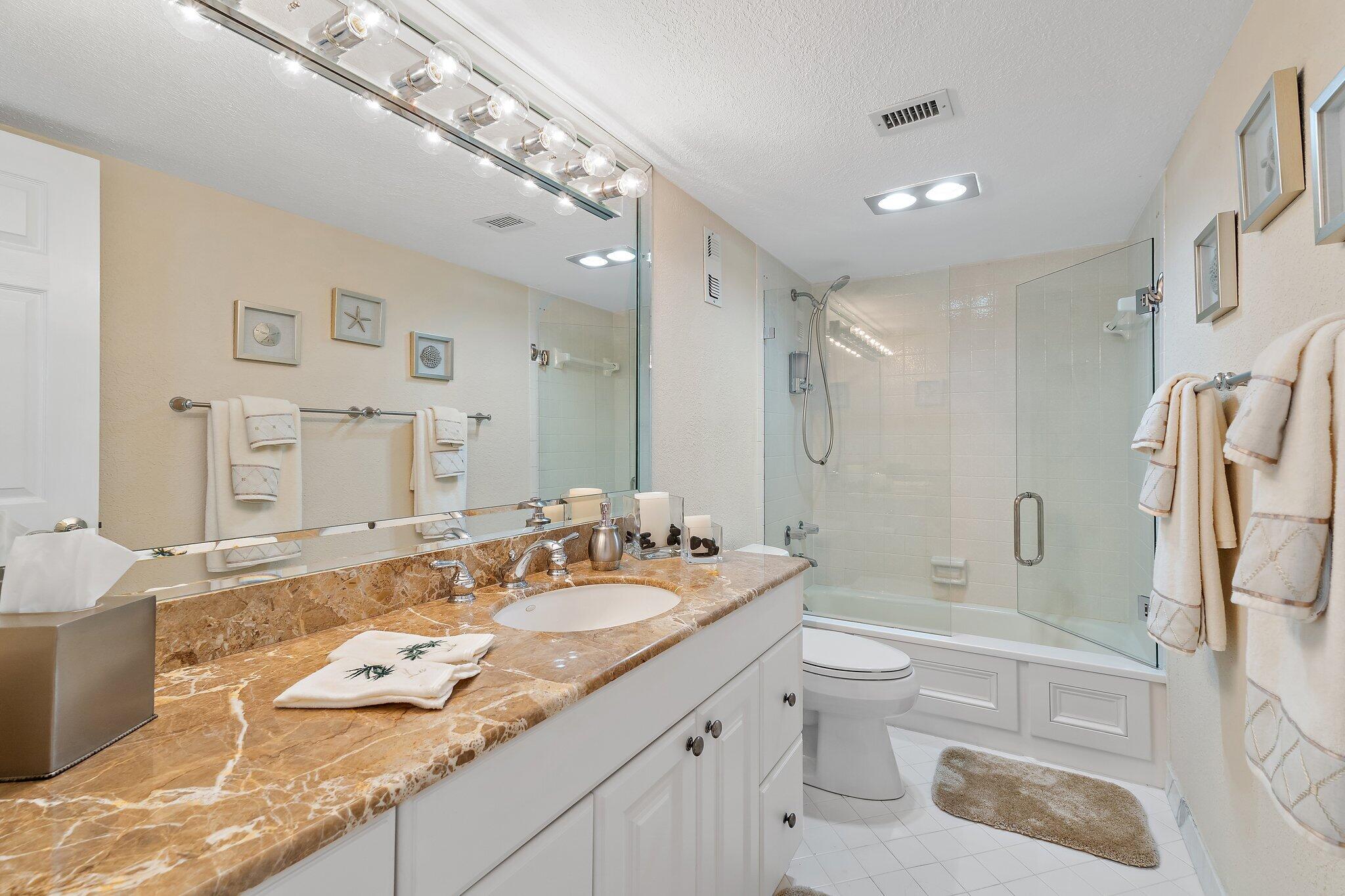 Undisclosed Address Singer Island, FL 33404 - Photo 31 of 77 a bathroom with a granite countertop sink toilet and shower